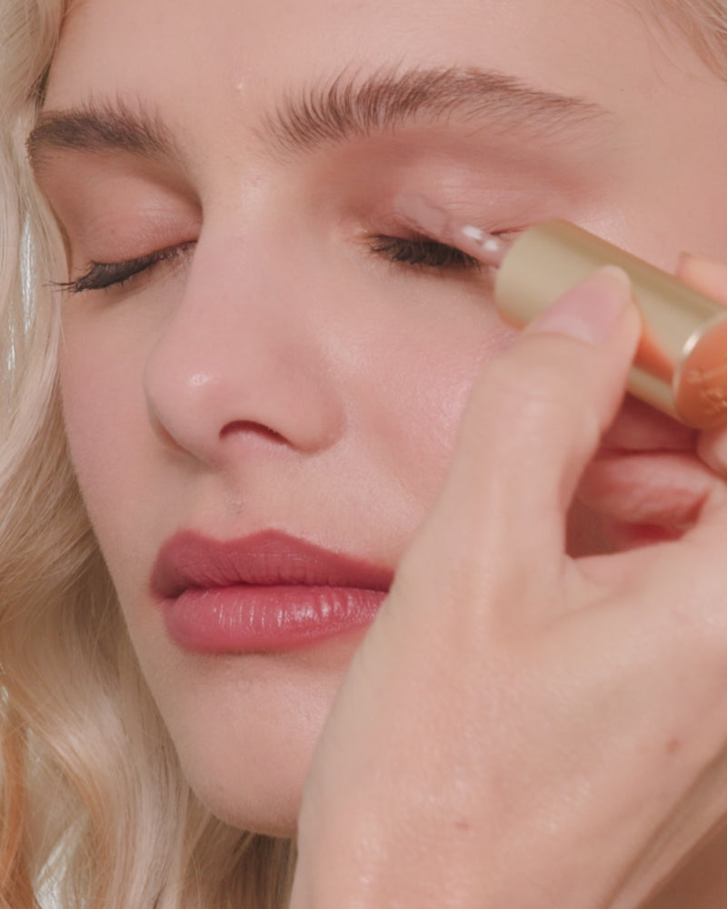 Video of Lisa applying cool mauve Ione Liquid Silk eyeshadow to a model's eyelids using a Seamless Skin Eye brush. Cut to model displaying her eyeshadow after final application.