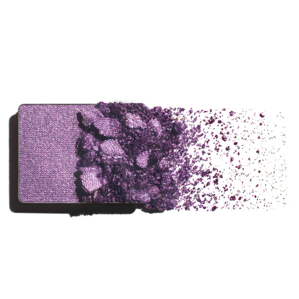 Makeup eyeshadow refill with lavender and hot pink pearl powder on a white background