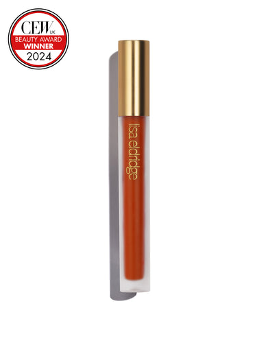 Orange-red liquid lip colour with gold cap on a white background, featuring a CEW Beauty Award Winner 2024 badge.