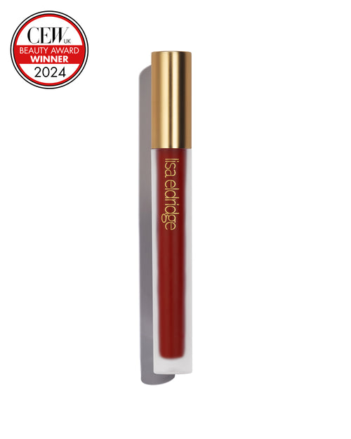 Earthy, brick red liquid lip colour with gold cap on a white background, featuring a CEW Beauty Award Winner 2024 badge.
