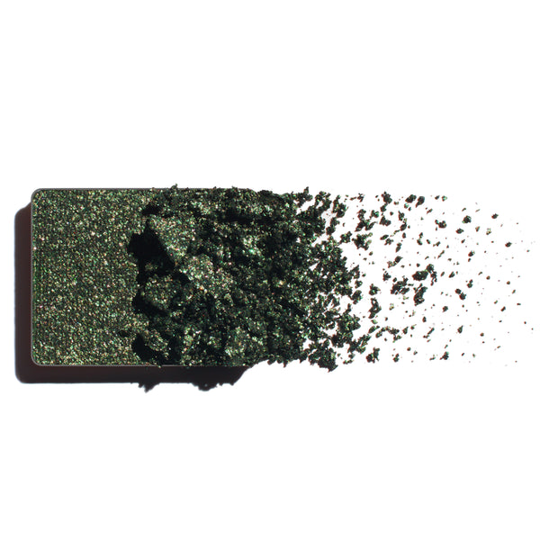 Makeup eyeshadow refill with rich emerald shimmer powder on a white background