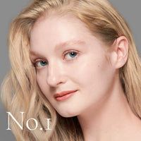 Lisa Eldridge Seamless Skin Foundation in a matte glass bottle with a gold lid. The bottle says ‘Lisa eldridge SEAMLESS SKIN’.
bottleupright