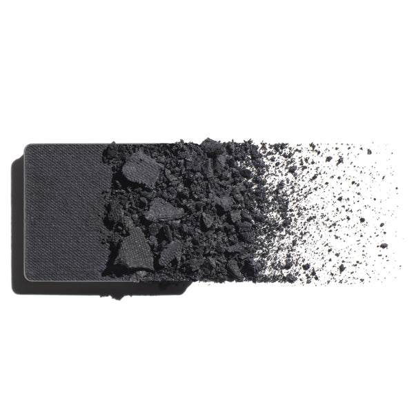 Makeup eyeshadow refill with cool, grey slate powder on a white background