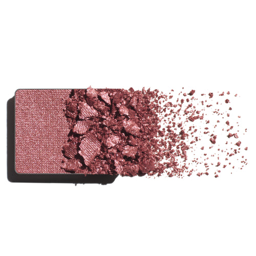 Makeup eyeshadow refill with warm rose powder on a white background